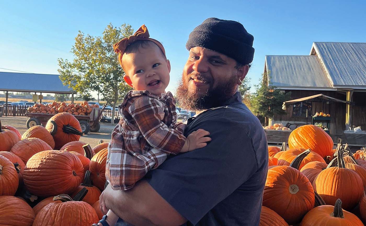 Mauricio Allen holding baby